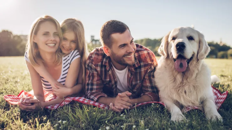 pennsylvania families can choose their electricity supplier. photo shows a mom, dad and daughter with dog in a field.