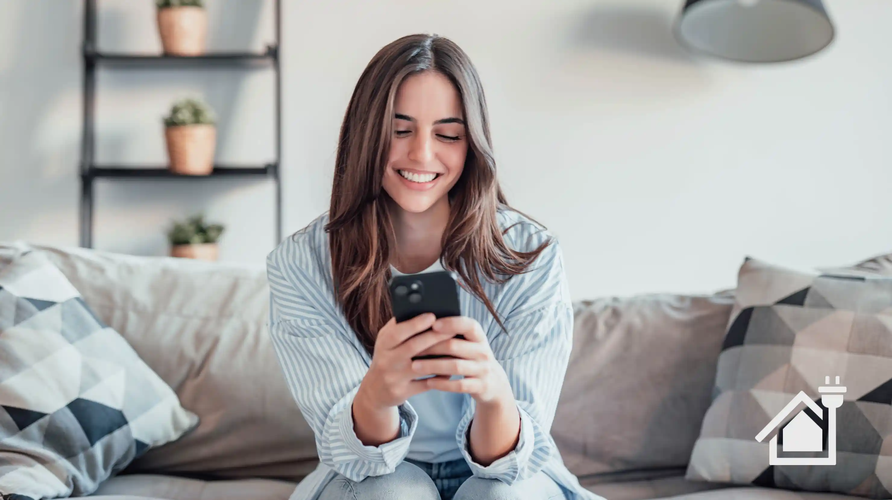 woman sits on couch using her phone to compare electricity rates in Texas