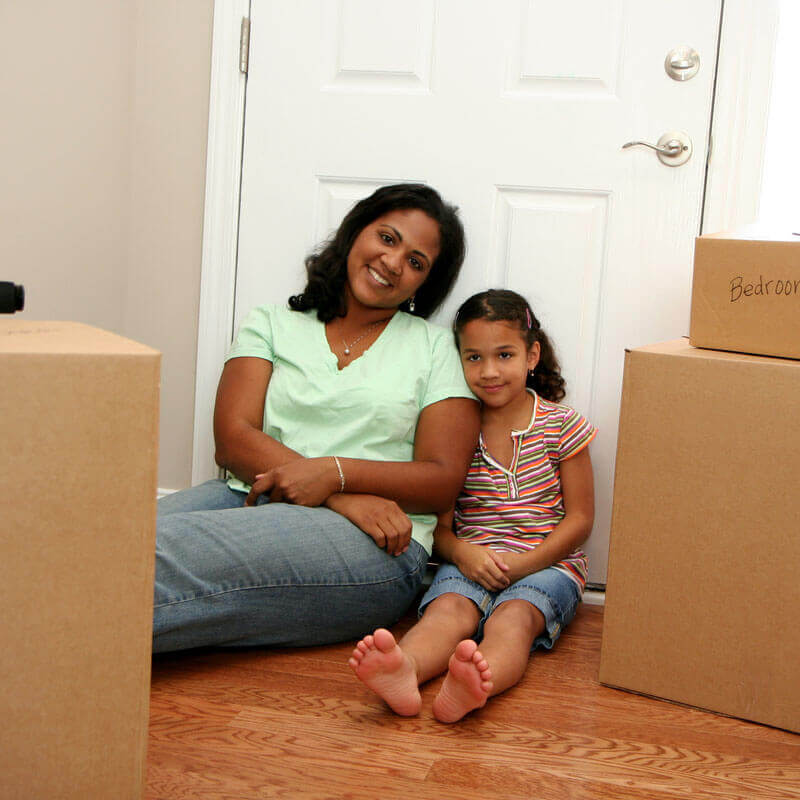 moving in to new home, woman, child and moving boxes.