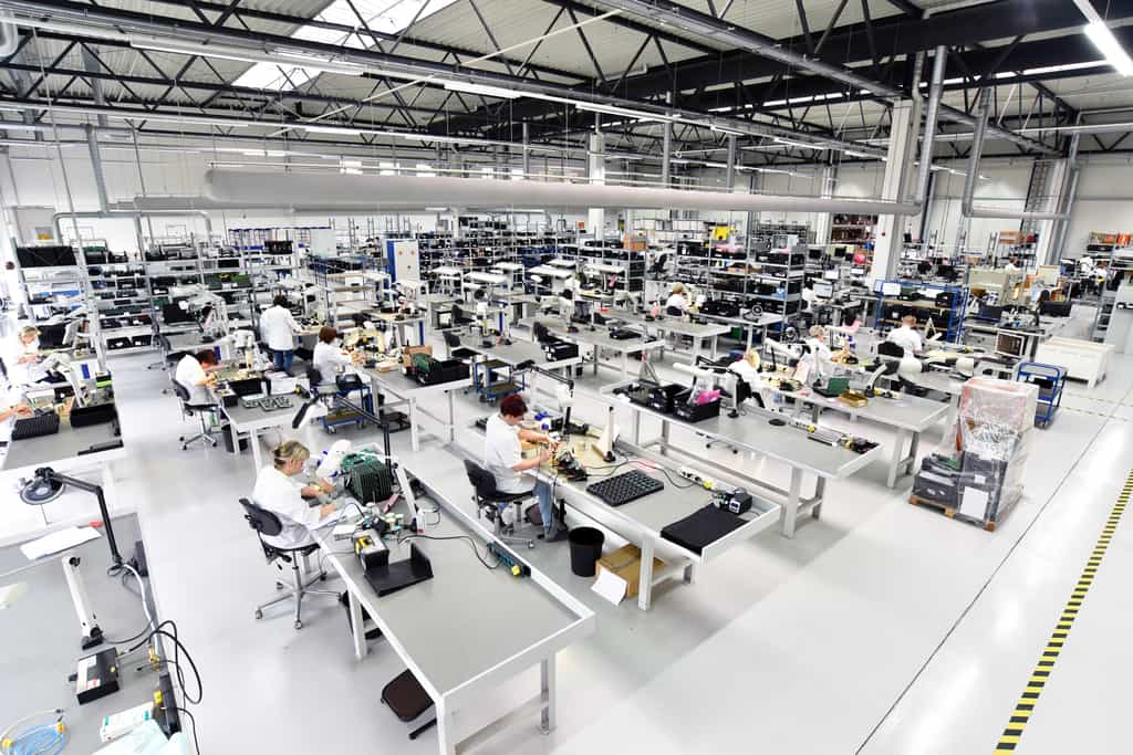 electricity for manufacturing can add up. Picture shows a manufacturing floor with a lot of light. 
