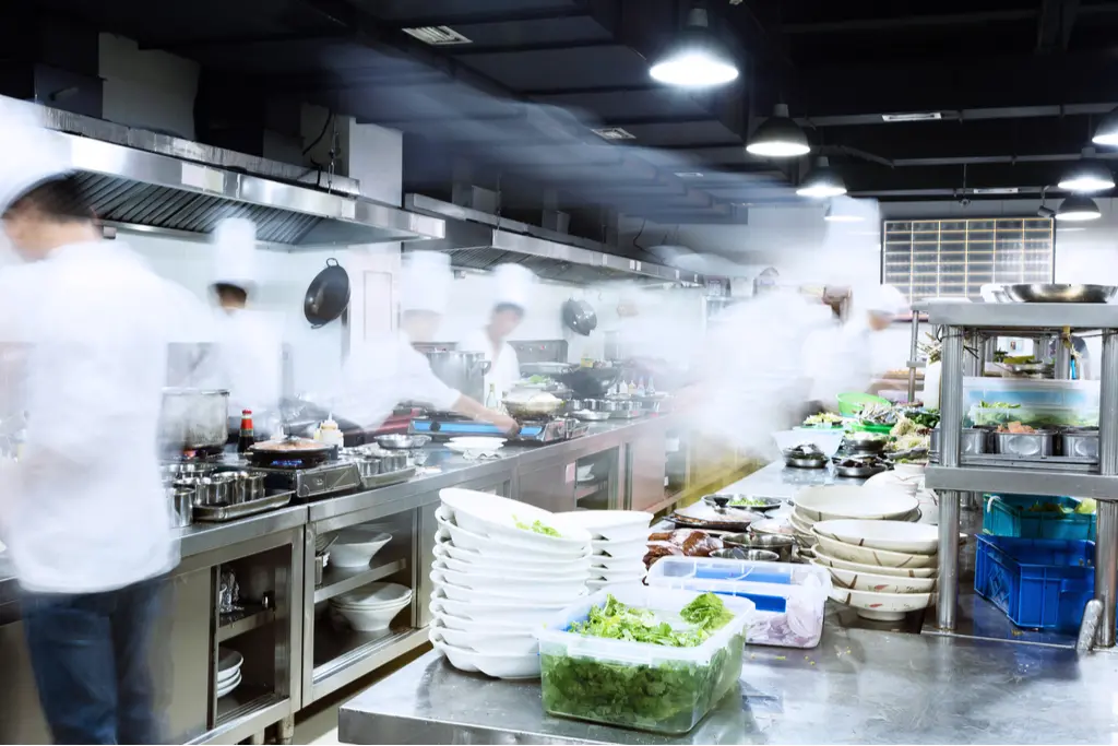 busy commercial kitchen with steam showing how electricity is used in restaurant kitchen