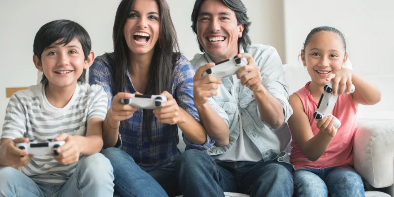 with free nights or free weekends you can use electricity when you want. image shows a family sitting on a couch and playing video games